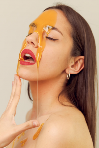  A girl with honey dripping down her skin