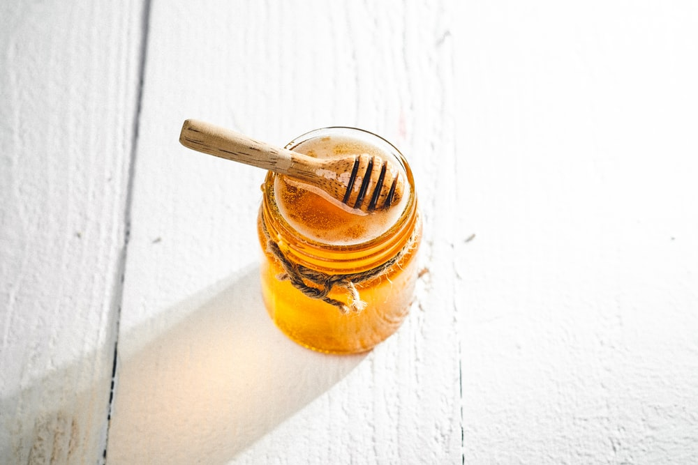 a spoon dipped in honey